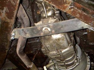 This photo shows the rear cross member support bracket I fabricated for the transmission. It's made from 1/4" T-1 steel plate, welded at the corners, drilled and attached to the Alpine frame.  (There is more clearance with the exhaust pipe than the photo seems to show.)